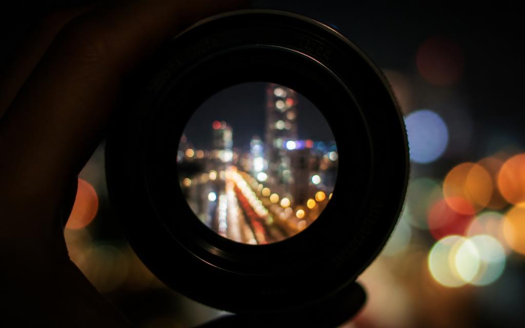 Blurry lights of a night city through a camera lens